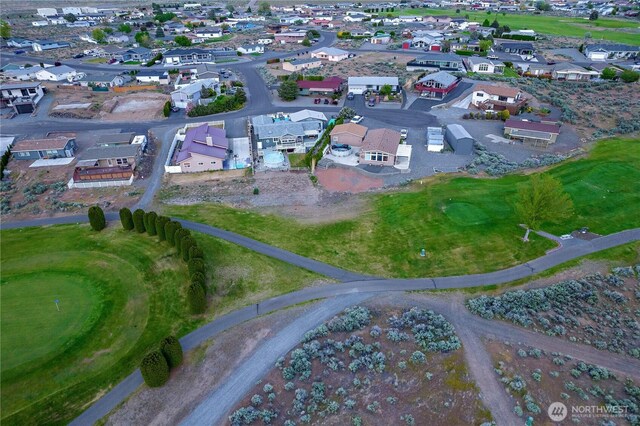 birds eye view of property with view of golf course and a residential view