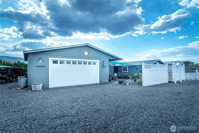 exterior space with a garage and fence