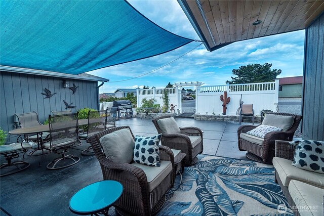 view of patio featuring outdoor dining area, fence, and area for grilling