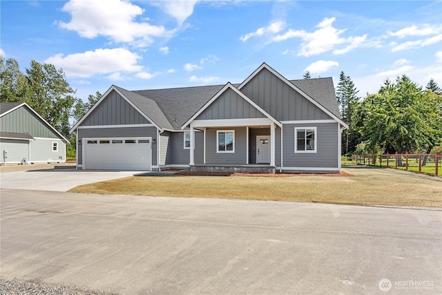 1200 E Georgia Ln, Everson, WA 98247 - view of front of house with board and batten siding, driveway, an attached garage, a porch, and a shingled roof
