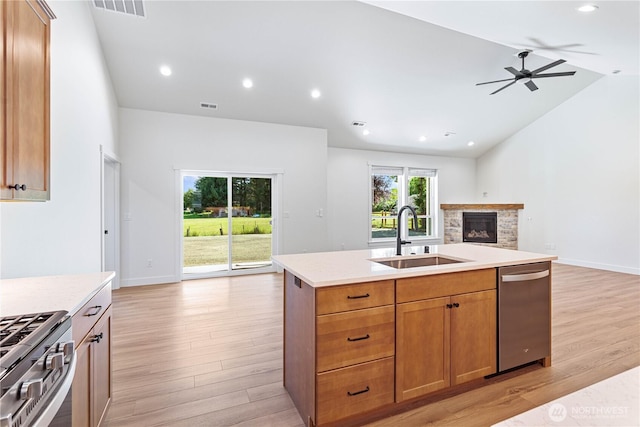 1200 E Georgia Ln, Everson, WA 98247 - kitchen with open floor plan, appliances with stainless steel finishes, light wood finished floors, a fireplace, and light countertops