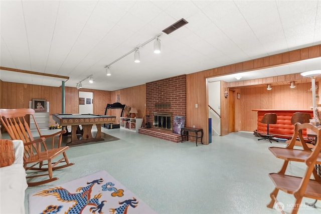 rec room featuring billiards, visible vents, a dry bar, a brick fireplace, and wooden walls