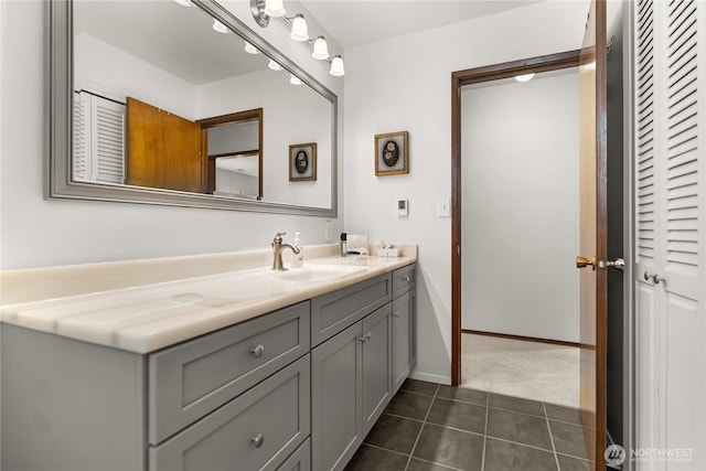 bathroom featuring vanity, baseboards, and tile patterned floors