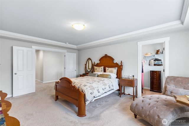 bedroom featuring baseboards, a tray ceiling, and light carpet