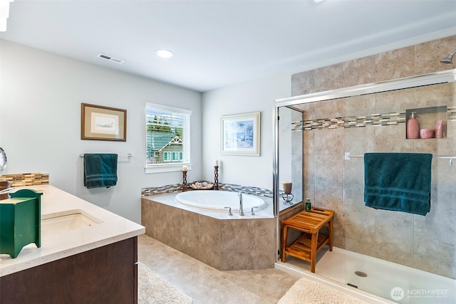 full bath featuring visible vents, a stall shower, a bath, tile patterned floors, and vanity