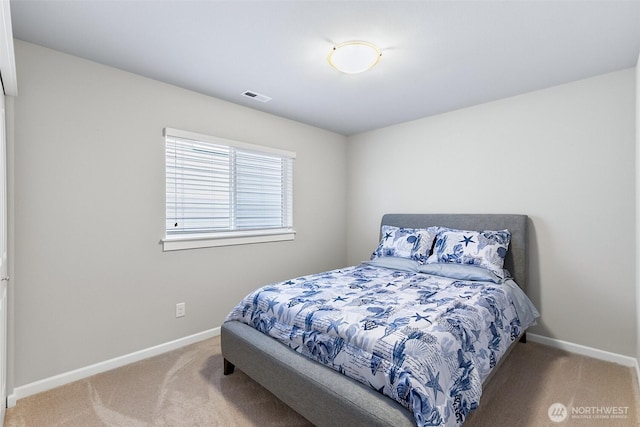 bedroom with baseboards, visible vents, and carpet