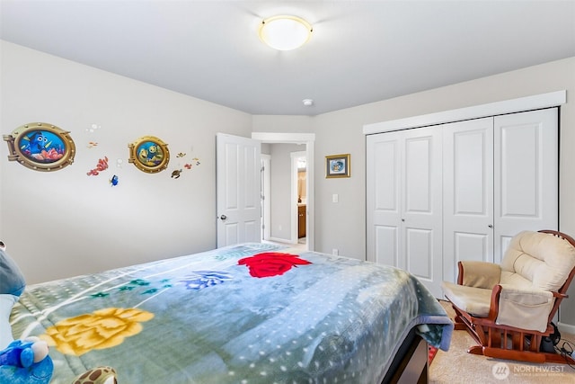 bedroom with carpet flooring, baseboards, and a closet
