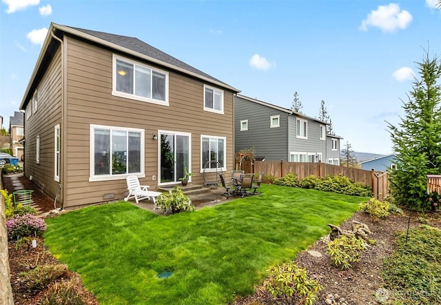 back of house with fence, a yard, and a patio area