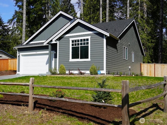 single story home featuring a garage, fence, driveway, and a front yard