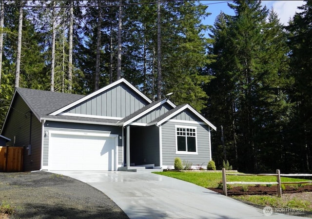 ranch-style house featuring board and batten siding, fence, concrete driveway, and a garage