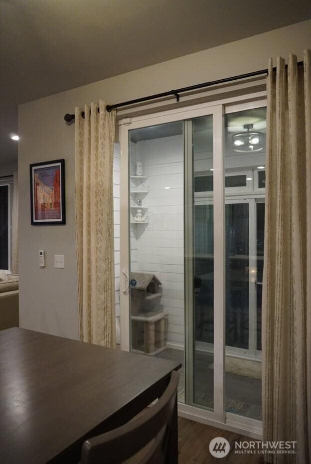 dining area featuring dark wood-style flooring