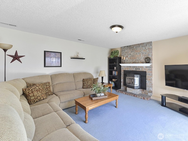living room with carpet floors, a textured ceiling, and visible vents