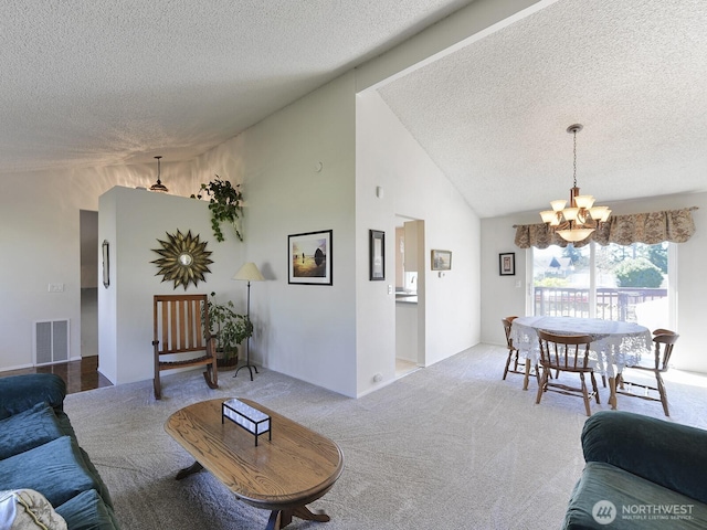 living room with visible vents, a textured ceiling, lofted ceiling, and a chandelier