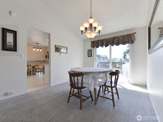 dining room with an inviting chandelier, a textured ceiling, vaulted ceiling, and light colored carpet