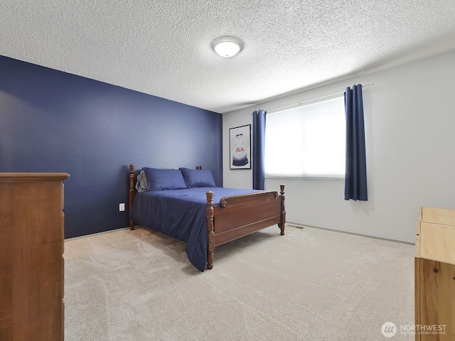 carpeted bedroom with a textured ceiling