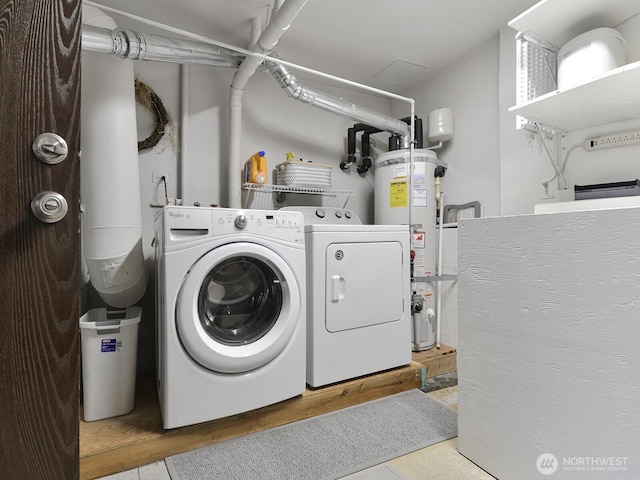 clothes washing area with laundry area, gas water heater, and washing machine and dryer