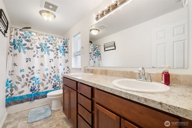 full bath featuring a sink, toilet, double vanity, and visible vents