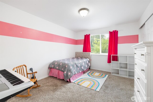 carpeted bedroom featuring baseboards