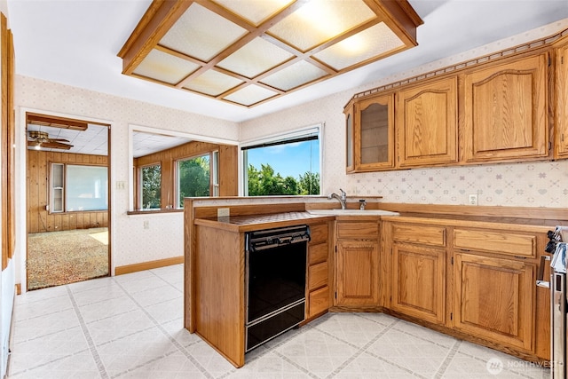 1115 Bigelow Ave NE, Olympia, WA 98506 - kitchen with black dishwasher, wallpapered walls, brown cabinetry, glass insert cabinets, and light countertops