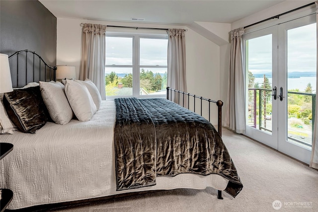 bedroom featuring access to outside, visible vents, multiple windows, and carpet