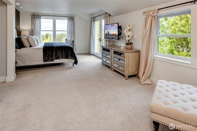 bedroom featuring access to exterior and light colored carpet