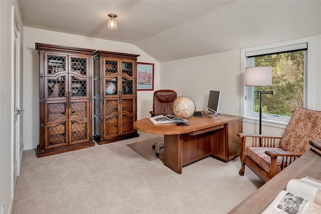 office space with lofted ceiling and light colored carpet