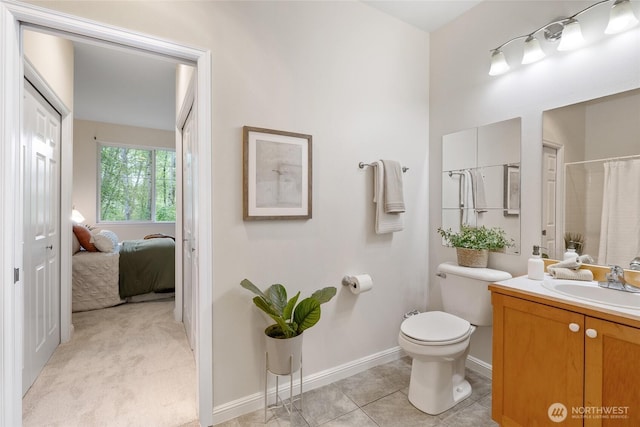 9229 122nd Ct NE Unit 13, Kirkland, WA 98033 - bathroom with tile patterned flooring, vanity, baseboards, toilet, and ensuite bath