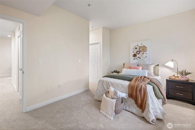 9229 122nd Ct NE Unit 13, Kirkland, WA 98033 - bedroom with baseboards, light carpet, and a closet