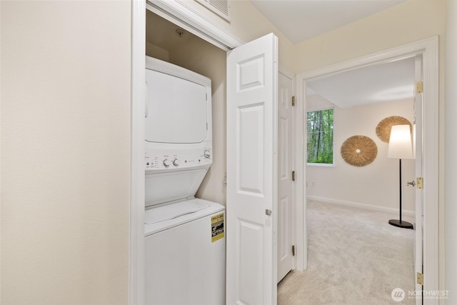 9229 122nd Ct NE Unit 13, Kirkland, WA 98033 - laundry room with laundry area, visible vents, stacked washer / dryer, light carpet, and baseboards