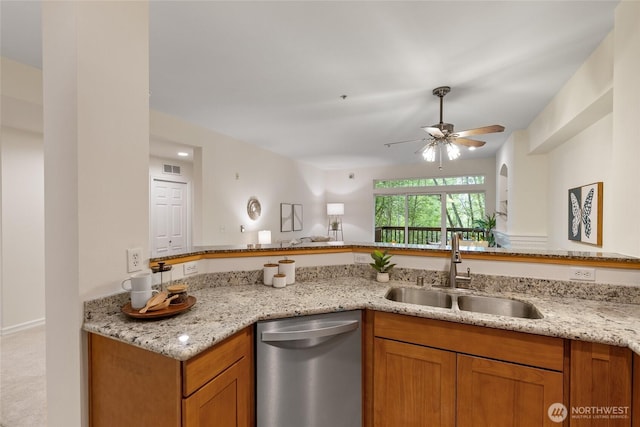 9229 122nd Ct NE Unit 13, Kirkland, WA 98033 - kitchen with light stone countertops, ceiling fan, a sink, brown cabinetry, and stainless steel dishwasher