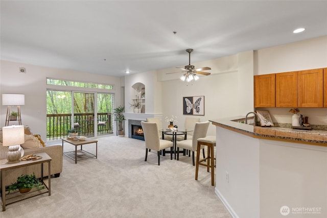 9229 122nd Ct NE Unit 13, Kirkland, WA 98033 - living area with ceiling fan, light carpet, and a premium fireplace