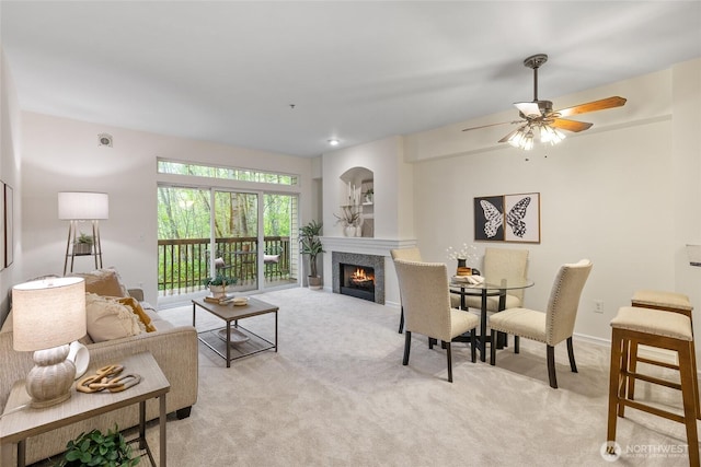 9229 122nd Ct NE Unit 13, Kirkland, WA 98033 - living room featuring light colored carpet, a ceiling fan, and a warm lit fireplace