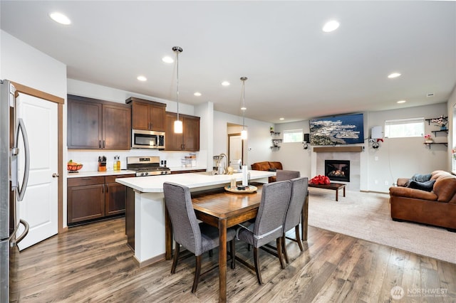 5198 Sophie St, Bremerton, WA 98312 - dining space with recessed lighting, dark wood finished floors, a tiled fireplace, and a wealth of natural light
