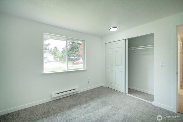 12120 218th Avenue Ct E, Bonney Lake, WA 98391 - unfurnished bedroom with carpet floors, a closet, baseboards, and a baseboard radiator