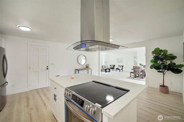 12120 218th Avenue Ct E, Bonney Lake, WA 98391 - kitchen with light stone counters, light wood-style floors, white cabinetry, island exhaust hood, and stainless steel appliances