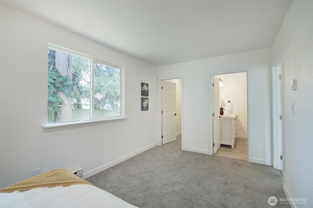 12120 218th Avenue Ct E, Bonney Lake, WA 98391 - bedroom with baseboards, connected bathroom, and carpet