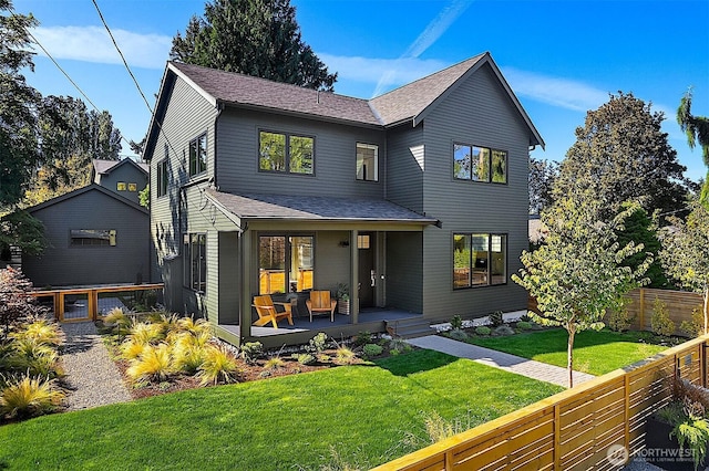 10419 41st Ave SW Unit A & B, Seattle, WA 98146 - back of house featuring a porch, a fenced backyard, and roof with shingles