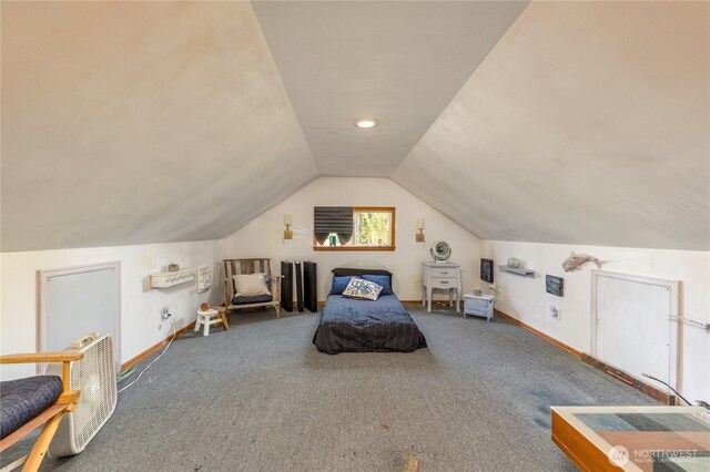 carpeted bedroom with baseboards and vaulted ceiling
