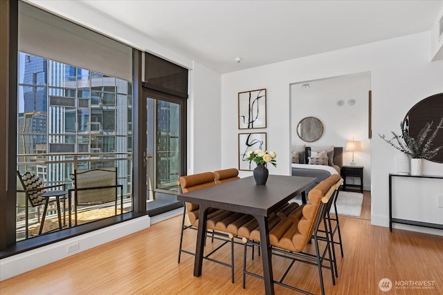 820 Blanchard St Unit 1507, Seattle, WA 98121 - dining area featuring baseboards and wood finished floors