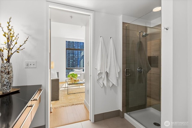820 Blanchard St Unit 1507, Seattle, WA 98121 - full bathroom featuring vanity, baseboards, and a stall shower