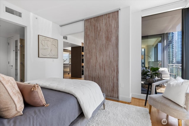 820 Blanchard St Unit 1507, Seattle, WA 98121 - bedroom featuring visible vents, wood finished floors, and access to outside