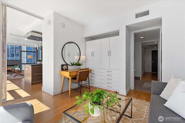 820 Blanchard St Unit 1507, Seattle, WA 98121 - living room featuring baseboards, light wood-type flooring, and visible vents