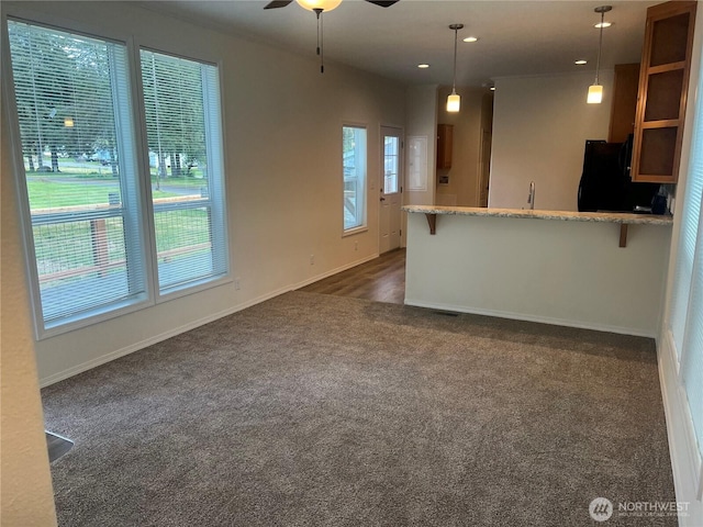 unfurnished living room with recessed lighting, baseboards, ceiling fan, and dark carpet