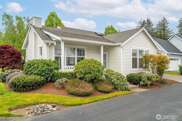 823 Landing Way, Centralia, WA 98531 - view of front of house featuring a shingled roof and a chimney