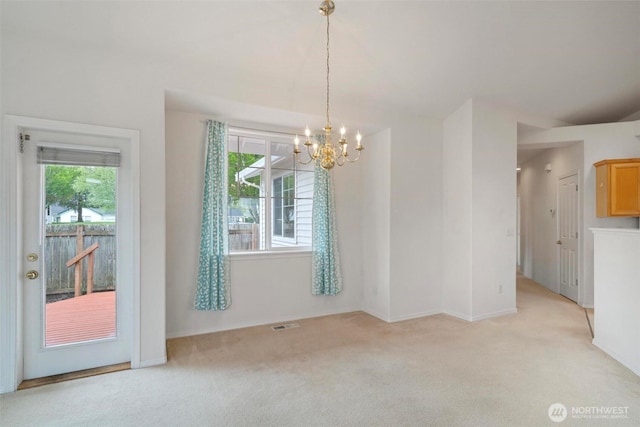 823 Landing Way, Centralia, WA 98531 - unfurnished dining area with a healthy amount of sunlight, light colored carpet, and a chandelier