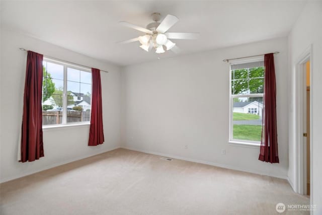 823 Landing Way, Centralia, WA 98531 - spare room with a ceiling fan, baseboards, and light carpet