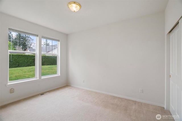 823 Landing Way, Centralia, WA 98531 - unfurnished bedroom with a closet, baseboards, light colored carpet, and visible vents