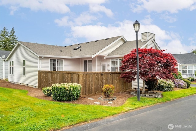 823 Landing Way, Centralia, WA 98531 - view of home's exterior featuring fence, a chimney, a yard, and roof with shingles