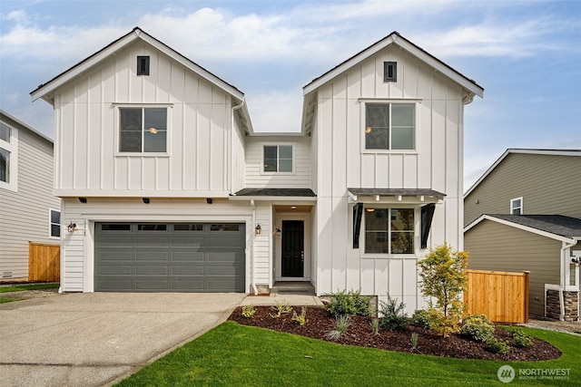modern inspired farmhouse with fence, board and batten siding, driveway, and a garage