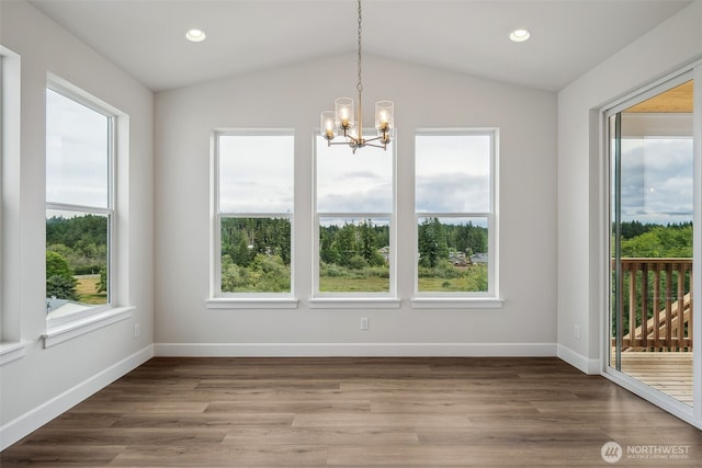 unfurnished dining area with recessed lighting, baseboards, a notable chandelier, and vaulted ceiling